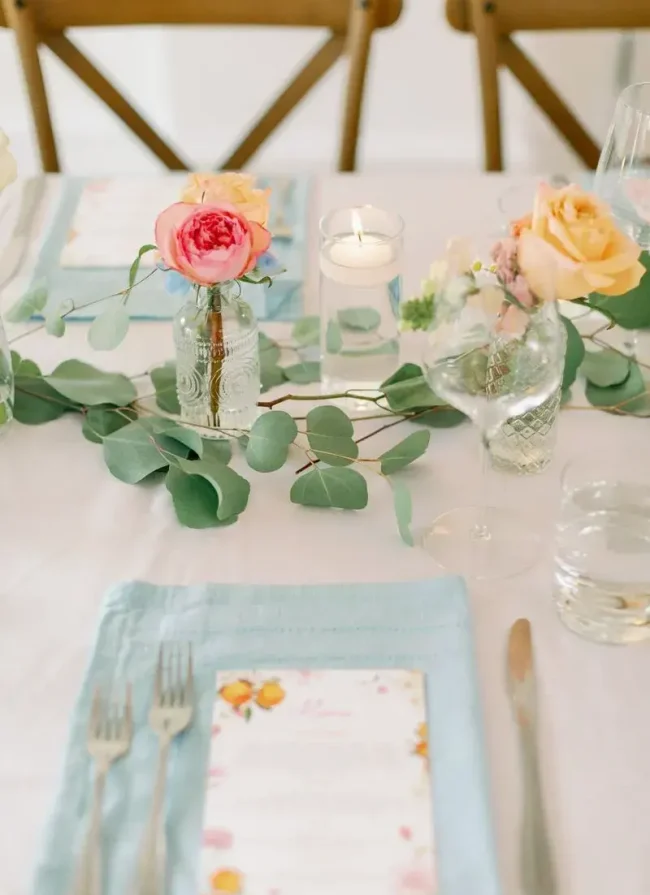 Elegant table setting with pastel roses, eucalyptus greenery, and personalized menu cards, showcasing a charming atmosphere for events like weddings or celebrations at Belvedere Lenox.